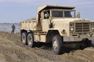 100510-G-1337B-580 PHOTO - Louisiana National Guard dumping sand to keep oil from inlet near Eden Island, LA